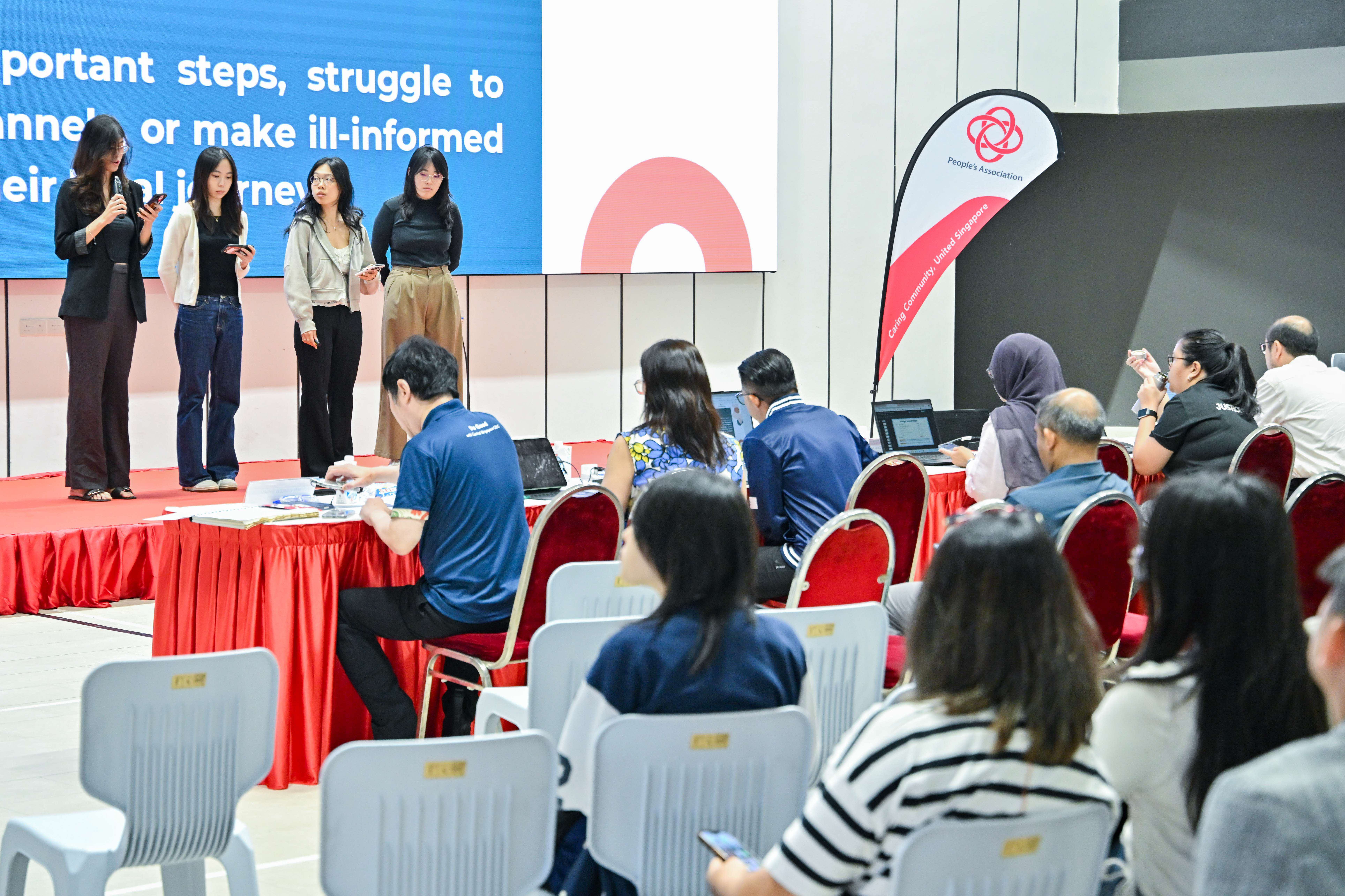 Four students explaining to the audience and judges